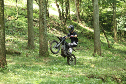 Doing a Wheelie on Black Dirt Bike E Ride Pro S on a Trail