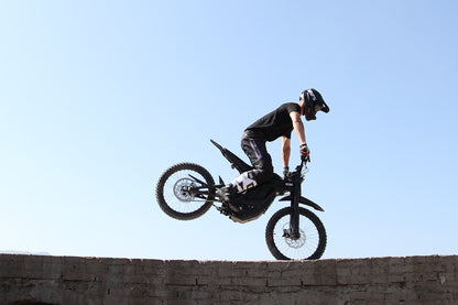 Doing a Wheelie on Black Dirt Bike E Ride Pro SS