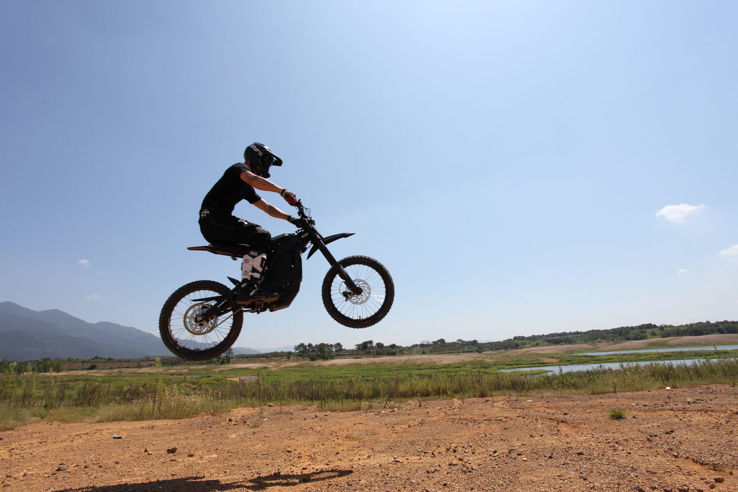 Doing a Jump on Black Dirt Bike E Ride Pro SS