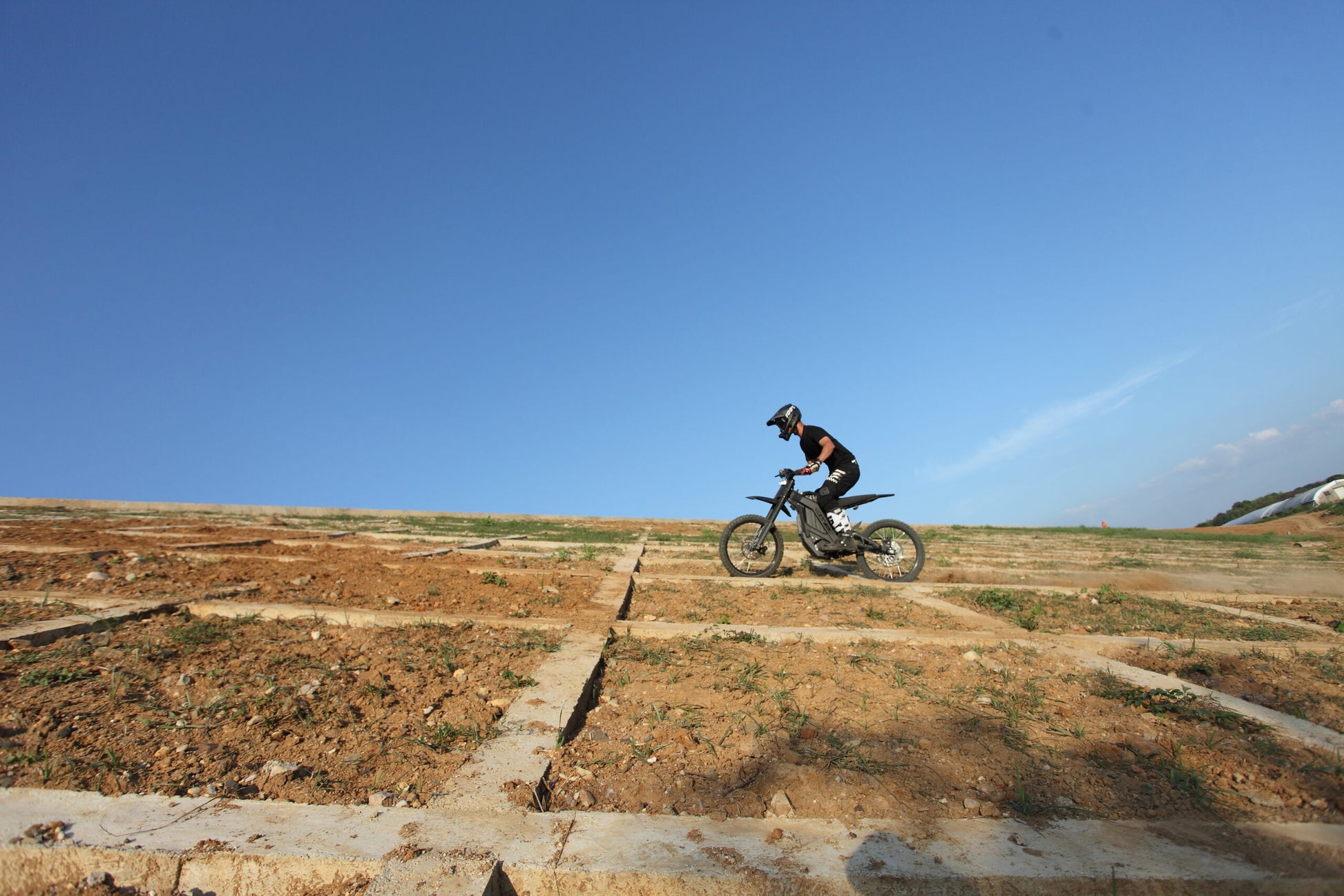 Riding Black Dirt Bike E Ride Pro SS on mud